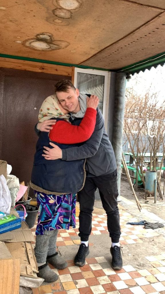 One of our missionaries, Vlad, being hugged and kissed by a 'Babusya' after delivering food and supplies