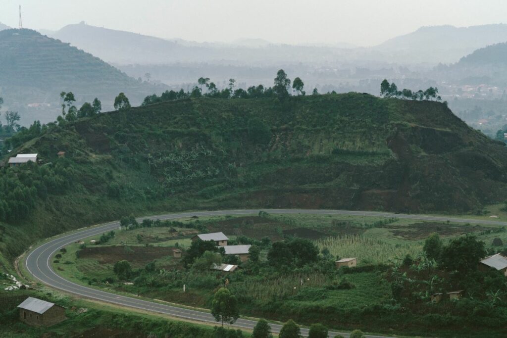 Mountain landscape in Africa with houses and a road in the distance. Photo by Random Institute on Unsplash.