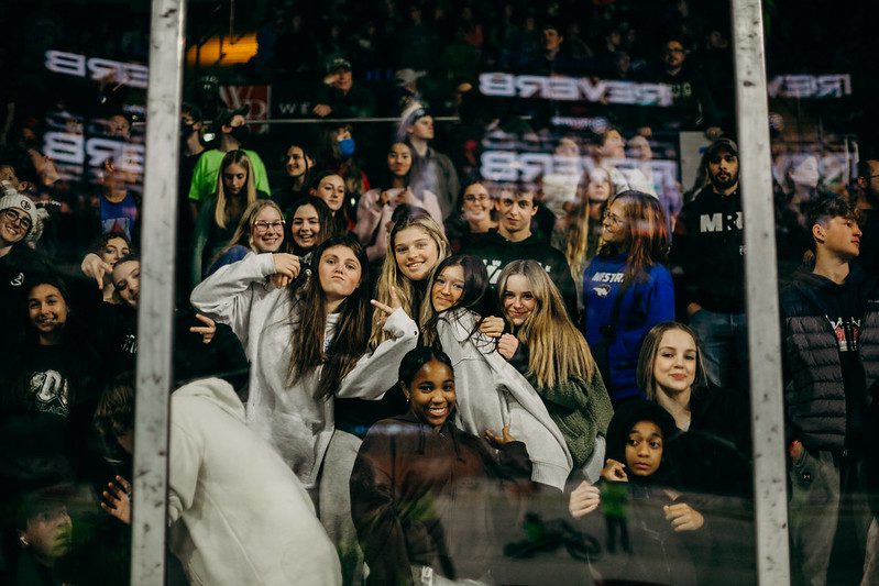 Group of happy teens smiling in a hockey arena. Photo by Word of Life Fellowship on Flickr.

